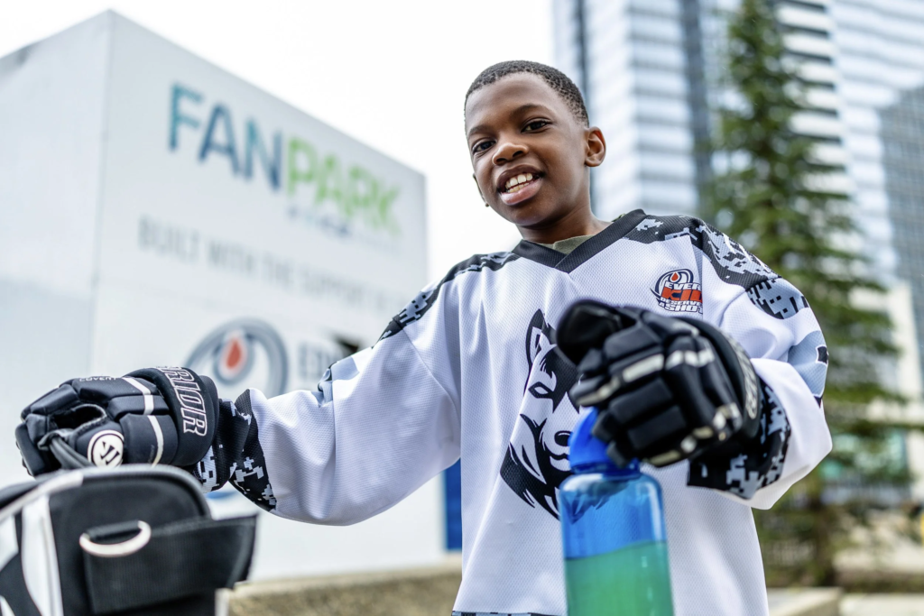 Children playing soccer in Edmonton supported by PASS Canada newcomer settlement services